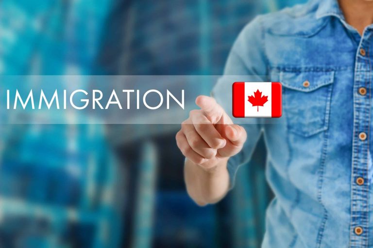 Person in a denim shirt points at a virtual button labeled “Immigration” with a Canadian flag icon, against a blurred blue background.